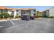 Condo building with parking lot and surrounding landscape at 1515 Pinellas Bayway S # B28, Tierra Verde, FL 33715