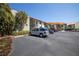 Condo building with parking and tropical landscaping at 1515 Pinellas Bayway S # B28, Tierra Verde, FL 33715