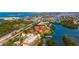 Aerial view showing home's location near water, tennis courts, and other amenities at 1515 Pinellas Bayway S # B28, Tierra Verde, FL 33715
