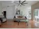 Open living room with hardwood floors, kitchen view, and access to patio at 8111 Riverside Ne Dr, St Petersburg, FL 33702