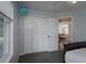 Bedroom with white closet doors and a view into the living area at 8111 Riverside Ne Dr, St Petersburg, FL 33702