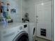 Laundry room with washer, dryer, and ample storage shelving at 8111 Riverside Ne Dr, St Petersburg, FL 33702