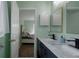 Bathroom with double vanity and view of bedroom at 8111 Riverside Ne Dr, St Petersburg, FL 33702