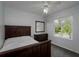 Cozy bedroom with dark wood furniture and window overlooking street at 8111 Riverside Ne Dr, St Petersburg, FL 33702