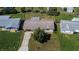 Charming single-story home with a well-manicured lawn, mature trees, and a paved driveway at 10801 Fillmore Ave, Port Richey, FL 34668