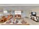 Bright living room featuring neutral tile flooring, stylish furnishings, and ample natural light at 10801 Fillmore Ave, Port Richey, FL 34668