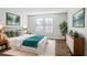 Spacious bedroom with wood floors and teal bedding at 3121 Briar St, Wesley Chapel, FL 33543
