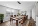 Bright dining room with wood flooring and modern light fixture at 3121 Briar St, Wesley Chapel, FL 33543