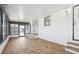 Bright screened porch with wood-look flooring, French doors, and a back door at 3121 Briar St, Wesley Chapel, FL 33543