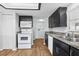 Kitchen with white appliances and dark cabinets at 3121 Briar St, Wesley Chapel, FL 33543