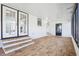 Bright screened porch with wood-look flooring, French doors, and a back door at 3121 Briar St, Wesley Chapel, FL 33543