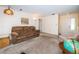 Comfortable living room featuring neutral carpet, cozy furniture and natural lighting at 3231 Macgregor Dr, Palm Harbor, FL 34684