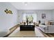 Living room with light beige couch, wooden coffee table, and wood floors at 5221 Chaney Ter, Port Charlotte, FL 33981