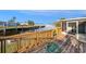 Wooden deck overlooking the waterfront with railings and a hose at 5346 Quist Dr, Port Richey, FL 34668