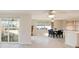 Bright dining area adjacent to the kitchen, featuring tile flooring and a sliding glass door at 5346 Quist Dr, Port Richey, FL 34668