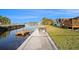Waterfront view of the dock with canal access and a boat lift at 5346 Quist Dr, Port Richey, FL 34668