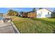 Exterior view of a home with a grassy yard, deck, and a boat lift at 5346 Quist Dr, Port Richey, FL 34668