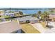 Waterfront home featuring an expansive view, a well-kept lawn, and concrete driveway at 5346 Quist Dr, Port Richey, FL 34668