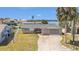 Charming single-story home featuring a concrete driveway and a well-maintained lawn at 5346 Quist Dr, Port Richey, FL 34668