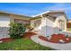 Close up of the home's entrance, featuring a garden bed and detailed stone accents at 5346 Quist Dr, Port Richey, FL 34668