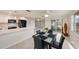 Bright kitchen and dining area with white cabinets, quartz countertops, and sliding glass doors to outdoor space at 5346 Quist Dr, Port Richey, FL 34668