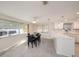 Open kitchen with white cabinetry, marble countertops, and view to the dining area at 5346 Quist Dr, Port Richey, FL 34668
