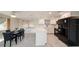 Modern kitchen features white cabinets, quartz countertops, stainless steel appliances, and an adjacent dining area at 5346 Quist Dr, Port Richey, FL 34668