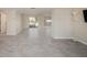 Open-concept living area with tile flooring, recessed lighting, and access to a screened porch at 5346 Quist Dr, Port Richey, FL 34668
