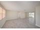 Spacious living room with light tile flooring and sliding glass doors to outdoor area at 5346 Quist Dr, Port Richey, FL 34668
