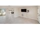 Open layout showcasing living, dining, and kitchen areas with tile floors and ample natural light at 5346 Quist Dr, Port Richey, FL 34668