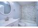 Updated bathroom features a white vanity, marble shower, and updated fixtures at 701 Mirror Lake N Dr # 309, St Petersburg, FL 33701