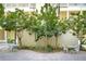 Relaxing courtyard with tables, chairs, and lush landscaping at 701 Mirror Lake N Dr # 309, St Petersburg, FL 33701