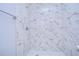 Shower with marble-look tile and pebble floor at 701 Mirror Lake N Dr # 309, St Petersburg, FL 33701