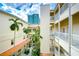 Inner courtyard view of a multi-story building with palm trees at 701 Mirror Lake N Dr # 309, St Petersburg, FL 33701