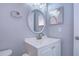 Updated bathroom with vanity, oval mirror, and modern fixtures at 701 Mirror Lake N Dr # 309, St Petersburg, FL 33701