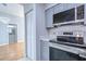 Modern kitchen with gray cabinets and stainless steel appliances at 701 Mirror Lake N Dr # 309, St Petersburg, FL 33701