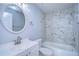 Updated bathroom features a white vanity, marble shower, and updated fixtures at 701 Mirror Lake N Dr # 309, St Petersburg, FL 33701