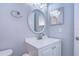 Updated bathroom with vanity, oval mirror, and modern fixtures at 701 Mirror Lake N Dr # 309, St Petersburg, FL 33701