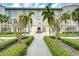 Charming building exterior with walkway and lush landscaping at 701 Mirror Lake N Dr # 309, St Petersburg, FL 33701