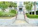 Elegant building entrance with stairs and manicured landscaping at 701 Mirror Lake N Dr # 309, St Petersburg, FL 33701