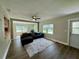 Light and airy living room with a sectional sofa, wood-look floors, and bay window at 1554 Elmwood St, Clearwater, FL 33755