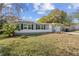 Newly renovated house with gray siding, white trim, and a grassy lawn at 1554 Elmwood St, Clearwater, FL 33755