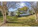 Newly renovated house with gray siding, white trim, and a grassy lawn at 1554 Elmwood St, Clearwater, FL 33755