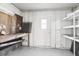 Workshop with pegboard walls, workbench, and shelving at 3121 Briar St, Wesley Chapel, FL 33543