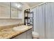 Simple bathroom with granite countertop and updated vanity at 10801 Fillmore Ave, Port Richey, FL 34668