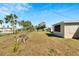 Large backyard with grassy area and garden at 10801 Fillmore Ave, Port Richey, FL 34668