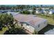 Aerial view of a single-story house with a brown roof and a green lawn at 10801 Fillmore Ave, Port Richey, FL 34668