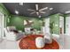 Living room with green walls, comfortable seating, and a circular rug at 120 Brightwater Dr # 2, Clearwater Beach, FL 33767