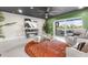 Relaxing living room with green walls, comfortable seating, and a view of the water at 120 Brightwater Dr # 2, Clearwater Beach, FL 33767