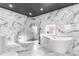 Spa-like bathroom with marble walls, a soaking tub, and a glass shower at 120 Brightwater Dr # 2, Clearwater Beach, FL 33767